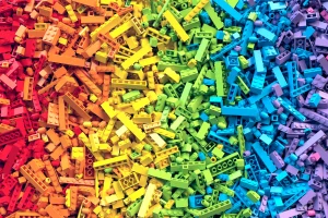 Colorful pile of LEGO bricks in a rainbow gradient, illustrating the LEGO turnaround strategy from chaos to alignment.