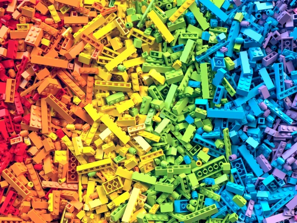 Colorful pile of LEGO bricks in a rainbow gradient, illustrating the LEGO turnaround strategy from chaos to alignment.